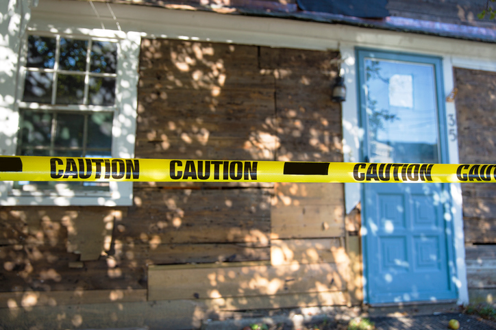 house fenced with a caution tape