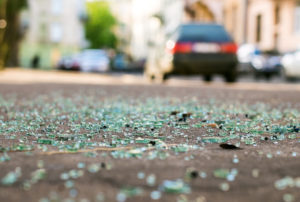 Shards of car glass on the street after car accident