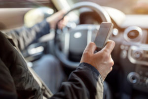 Using a phone in a car texting while driving 