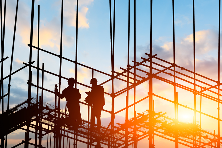 construction worker on construction site at sunset