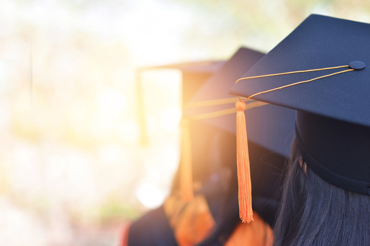 graduates wearing a yellow tassel hat