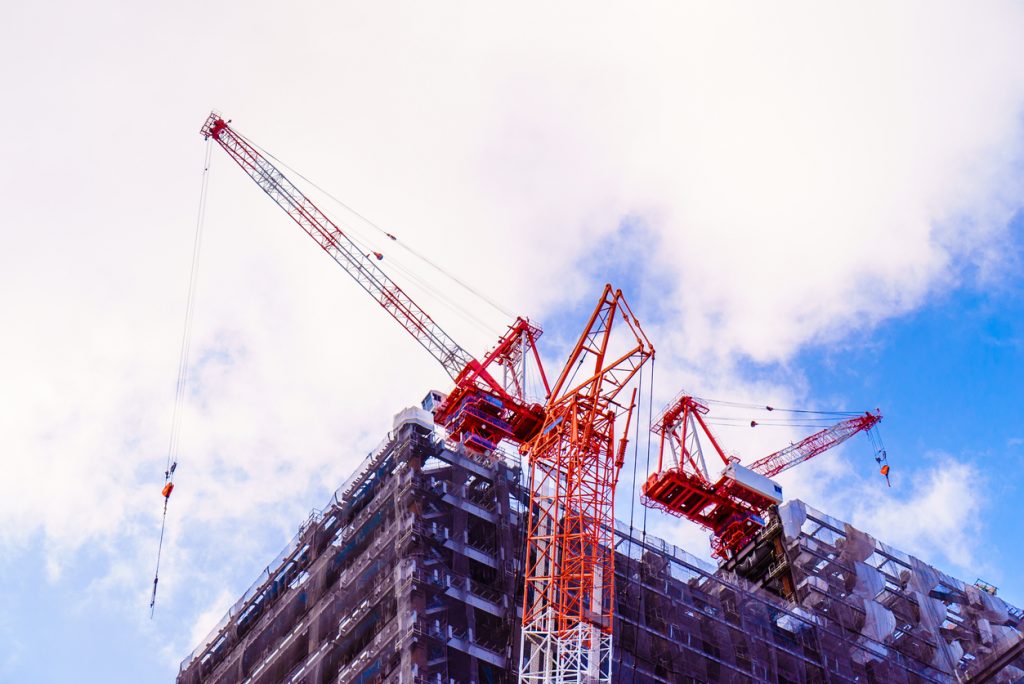 building under construction with crane