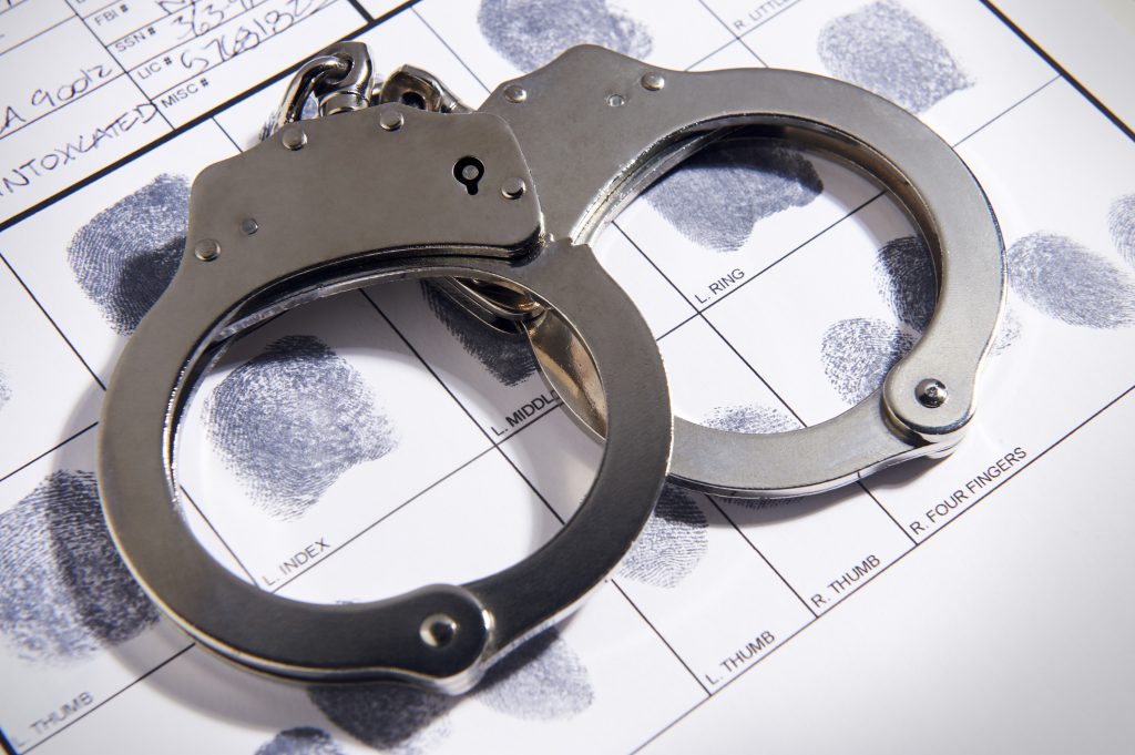 https://friedmanlevy.com/wp-content/uploads/2021/09/iStock-658011250-handcuffs-on-fingerprint-chart-1024x681.jpg