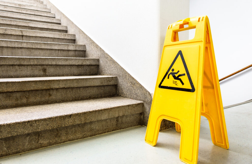 Caution: Slip & fall hazard sign in a building stairwell